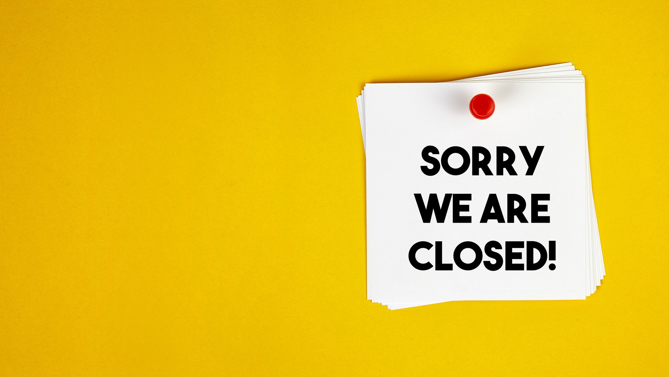 Sorry We Are Closed Sign on the Yellow Background